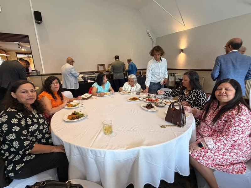 Guests enjoying lunch around a table
